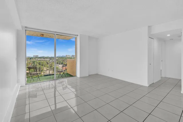 a view of a balcony with wooden floor and iron fence