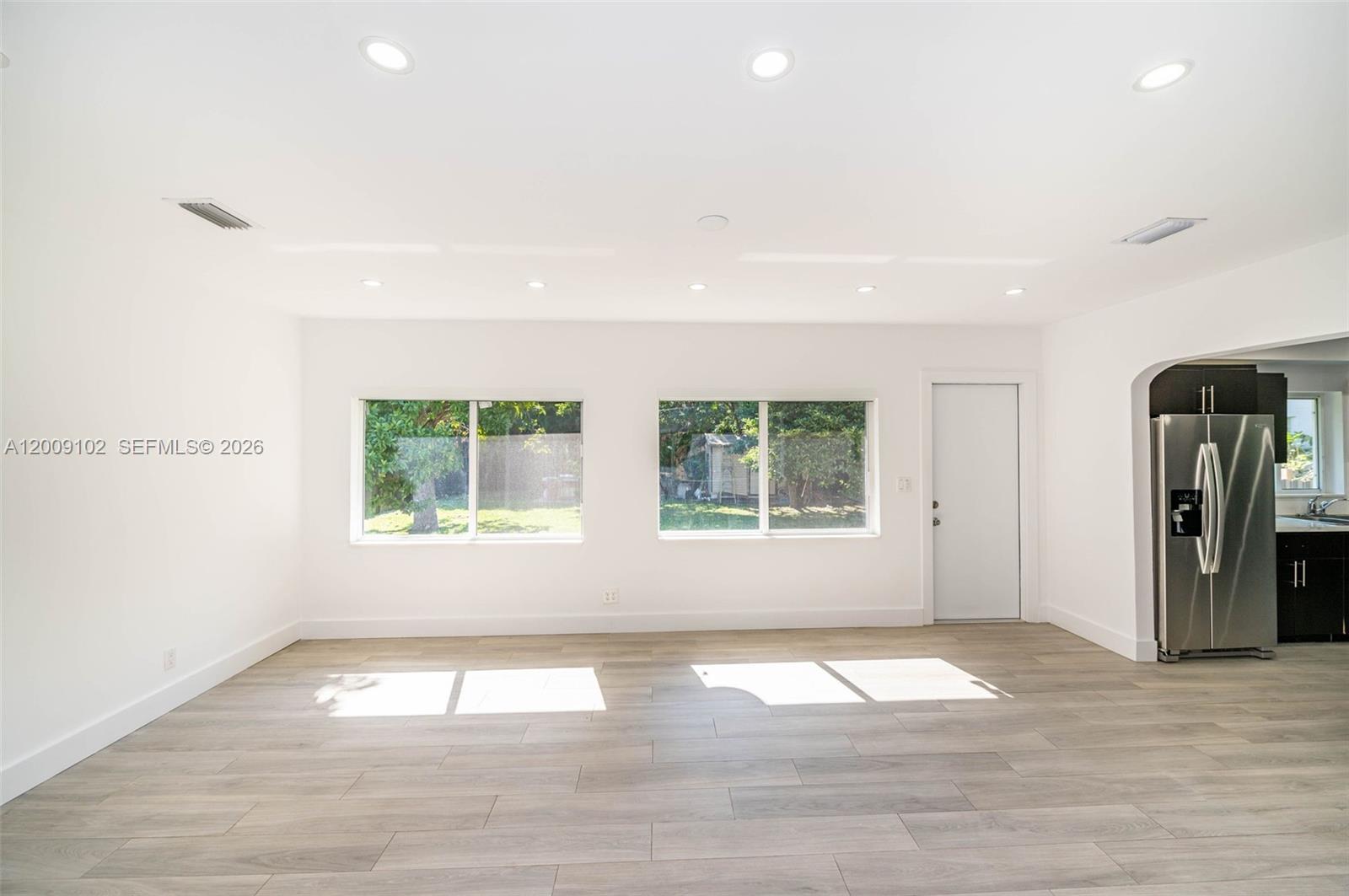 330 Southwest 27th Road Miami, FL 33129 - Photo 8 of 62 an empty room with wooden floor and windows
