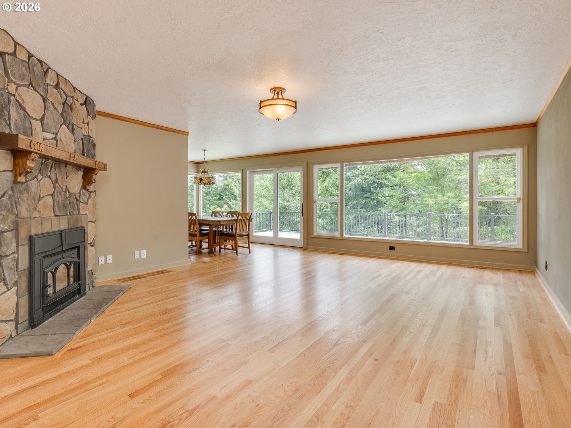 48140 Southeast Linhart Butte Road Sandy, OR 97055 - Photo 10 of 47 a view of empty room with wooden floor and fireplace