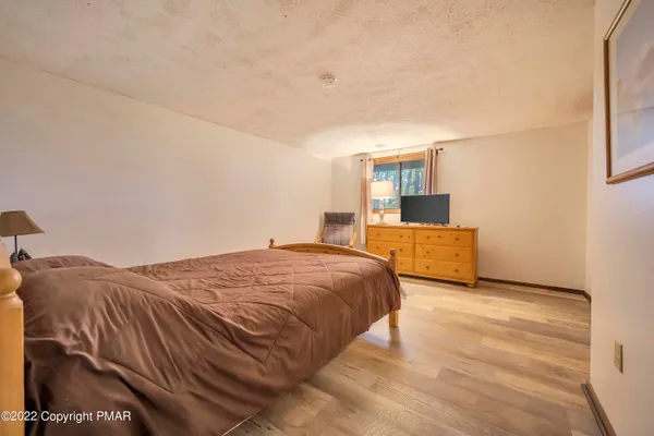 a spacious bedroom with a bed and cabinets