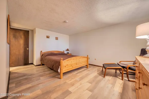 a bedroom with a bed and a desk