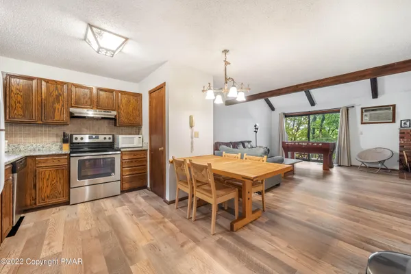 a kitchen with kitchen island a stove and a refrigerator