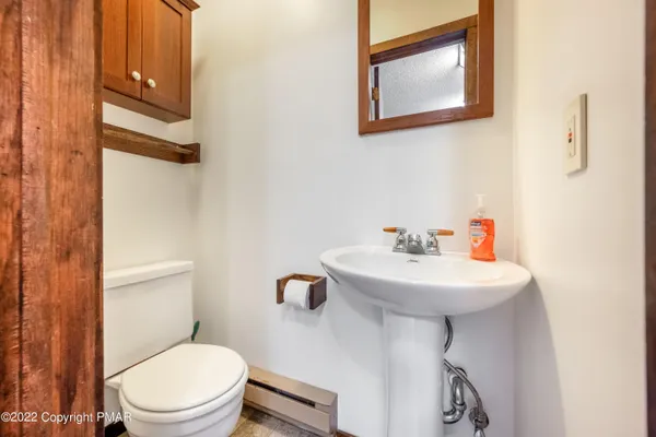 a bathroom with a sink a mirror and a toilet