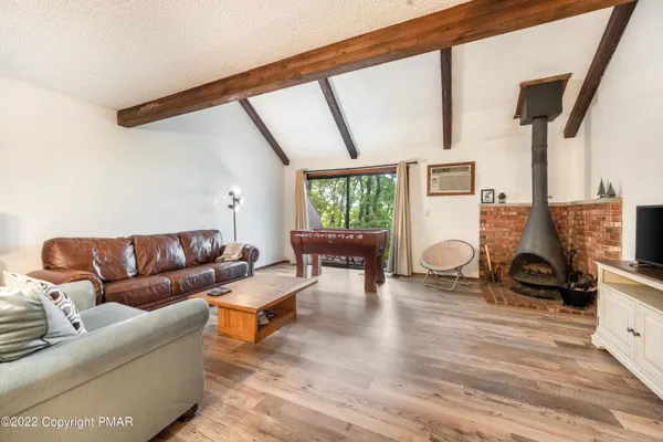 a living room with furniture and a floor to ceiling window