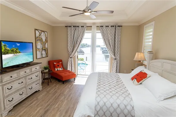 a bedroom with a bed and flat screen tv