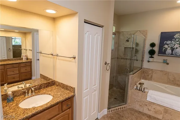 a bathroom with a granite countertop sink mirror and shower