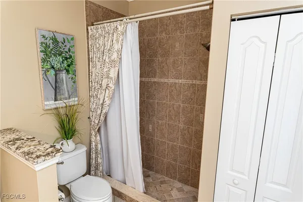 a bathroom with a shower curtain and a toilet