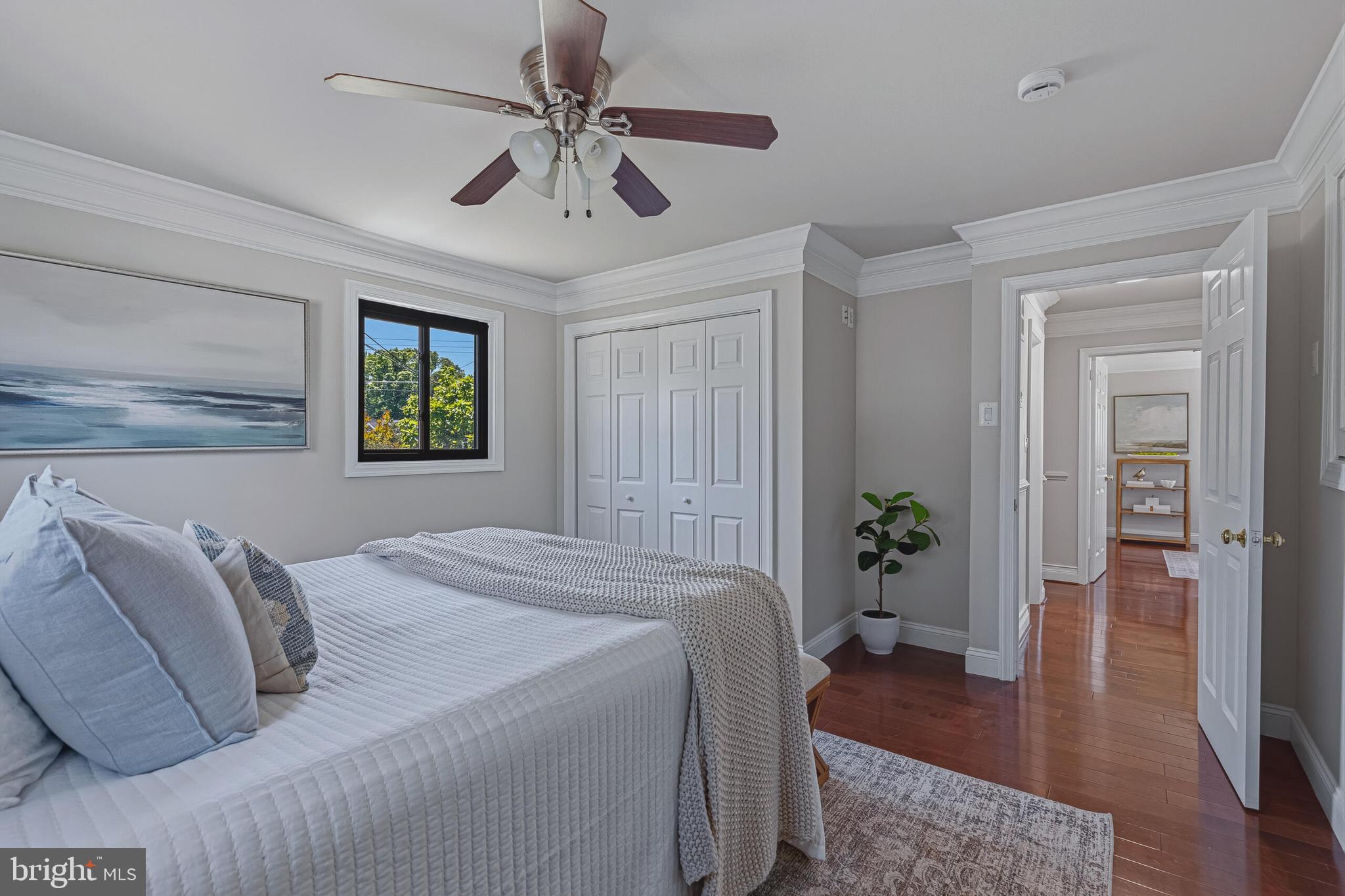5917 Flanders Street Springfield, VA 22150 - Photo 20 of 40 a bedroom with a large bed and a chandelier