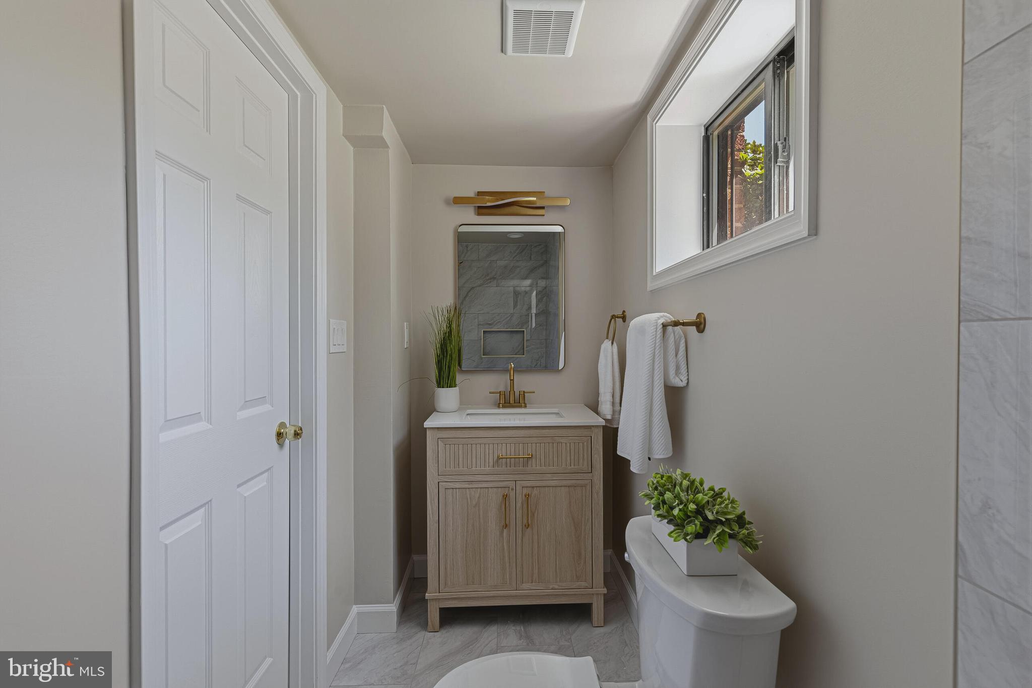 5917 Flanders Street Springfield, VA 22150 - Photo 28 of 40 a bathroom with a sink and mirror with bathtub