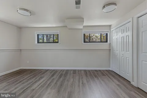 a view of a room with wooden floor and window