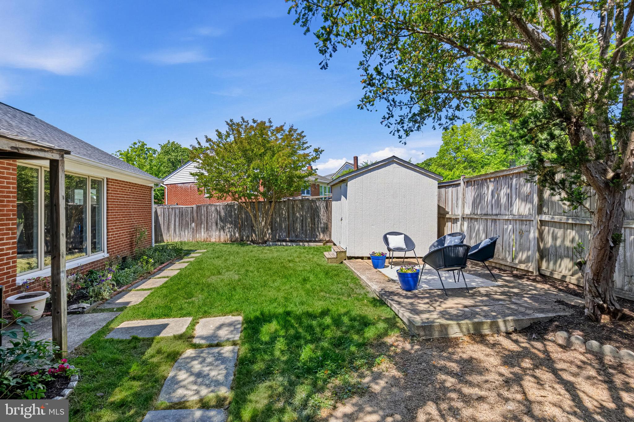 5917 Flanders Street Springfield, VA 22150 - Photo 34 of 40 a view of backyard with table and chairs and a large tree