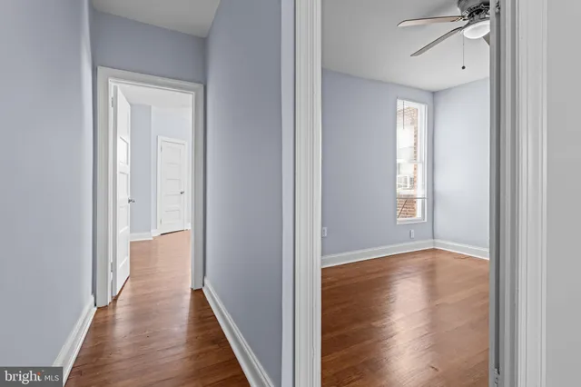 a view of a hallway with wooden floor
