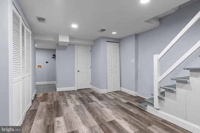 a view of hallway with wooden floor and staircase