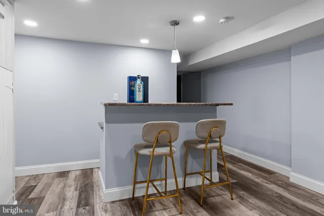 a view of a kitchen with furniture and wooden floor