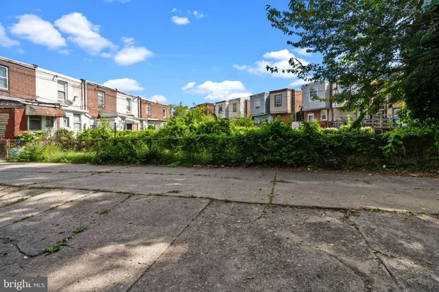 a view of a large building with a big yard and large trees
