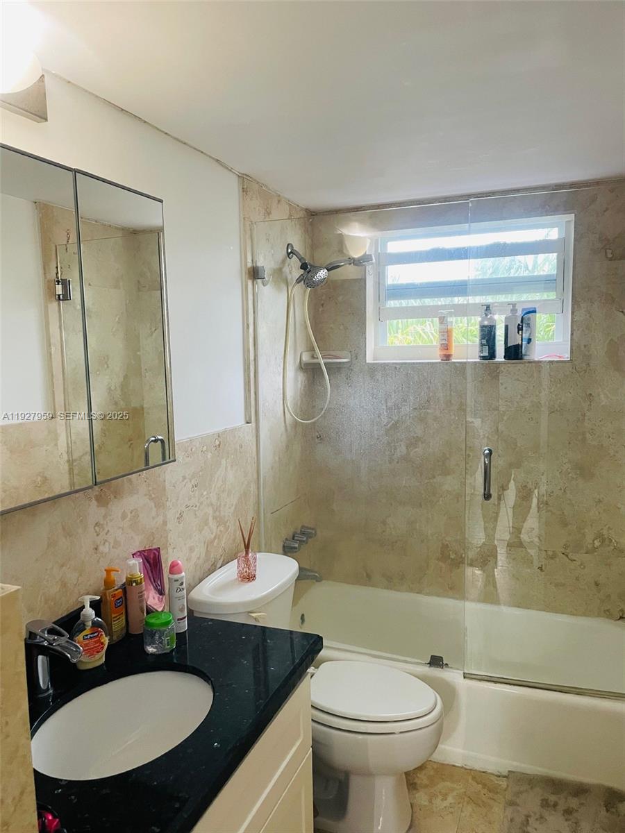 335 Collins Avenue, Unit 302 Miami Beach, FL 33139 - Photo 13 of 19 a bathroom with a sink toilet and shower