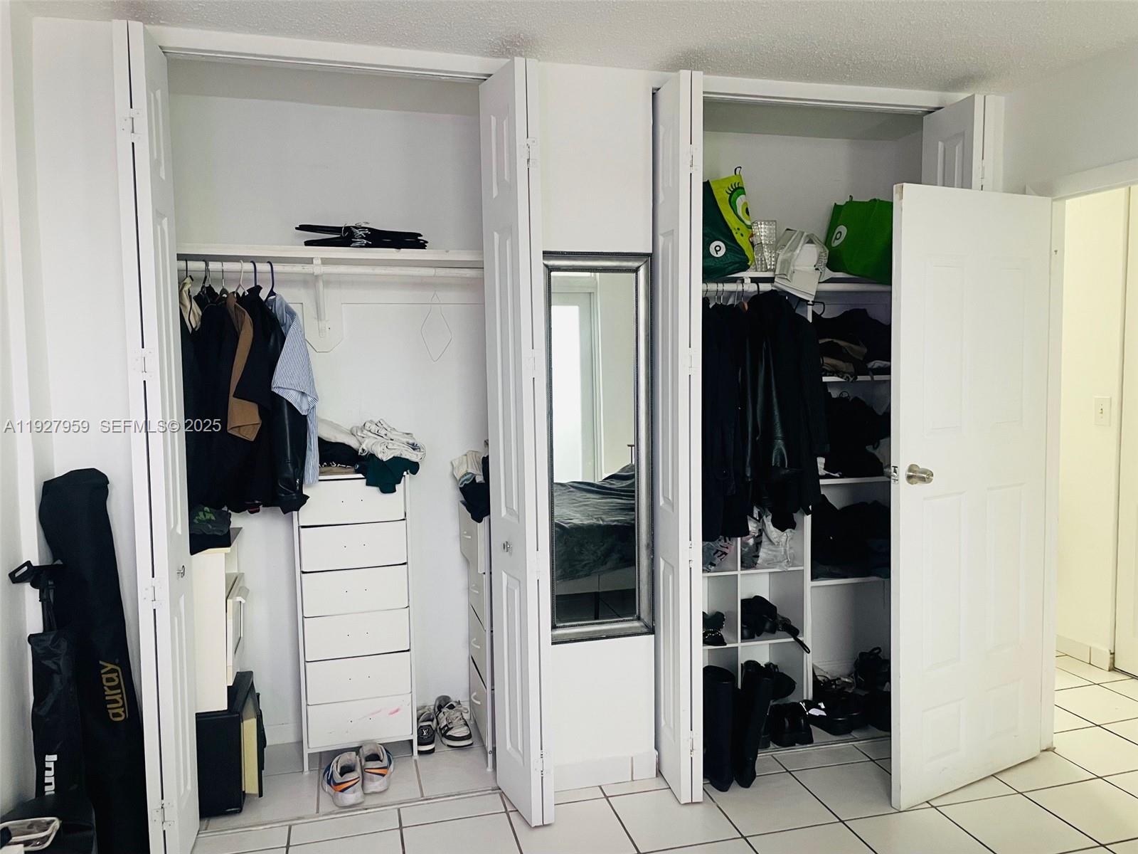 335 Collins Avenue, Unit 302 Miami Beach, FL 33139 - Photo 15 of 19 a view of walk in closet with clothes and shoes