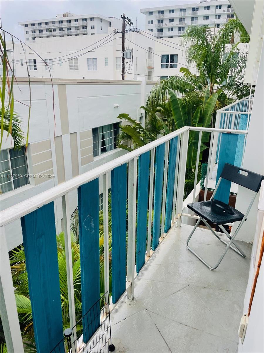 335 Collins Avenue, Unit 302 Miami Beach, FL 33139 - Photo 16 of 19 a balcony with table and chairs