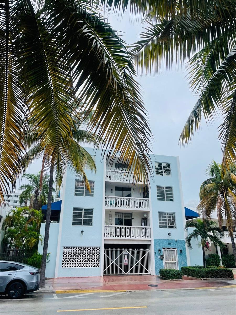 335 Collins Avenue, Unit 302 Miami Beach, FL 33139 - Photo 2 of 19 a view of a palm trees in front of a building