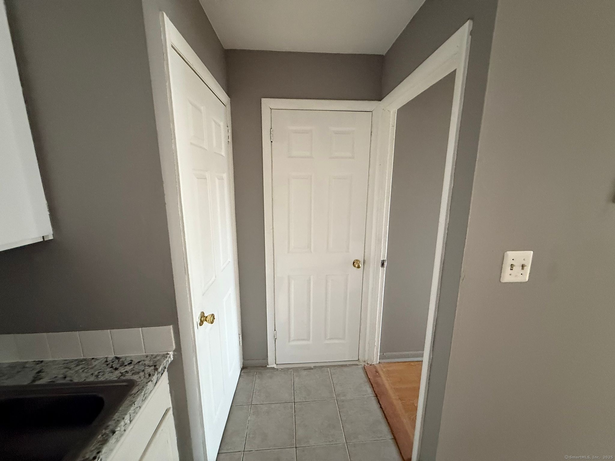 240 Oak Street, Unit 13 Bridgeport, CT 06604 - Photo 2 of 4 a view of a kitchen from the hallway