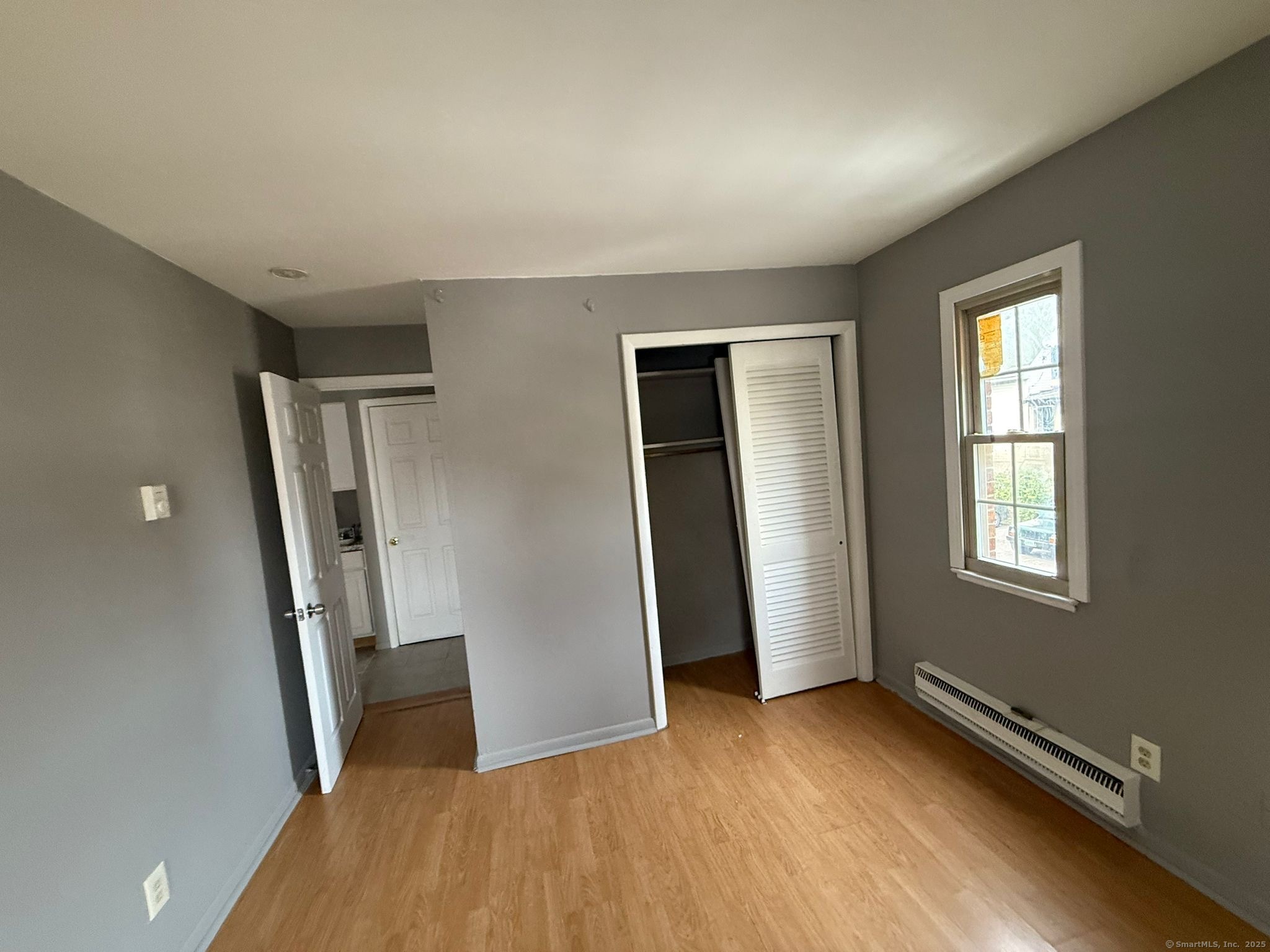 240 Oak Street, Unit 13 Bridgeport, CT 06604 - Photo 3 of 4 an empty room with windows and closet