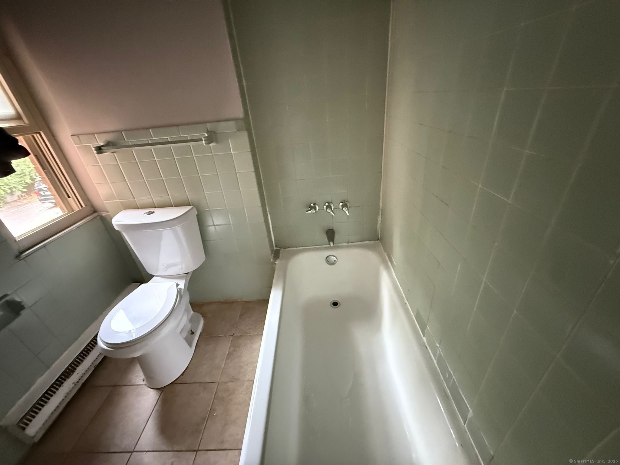 240 Oak Street, Unit 13 Bridgeport, CT 06604 - Photo 4 of 4 a bathroom with a toilet and a shower