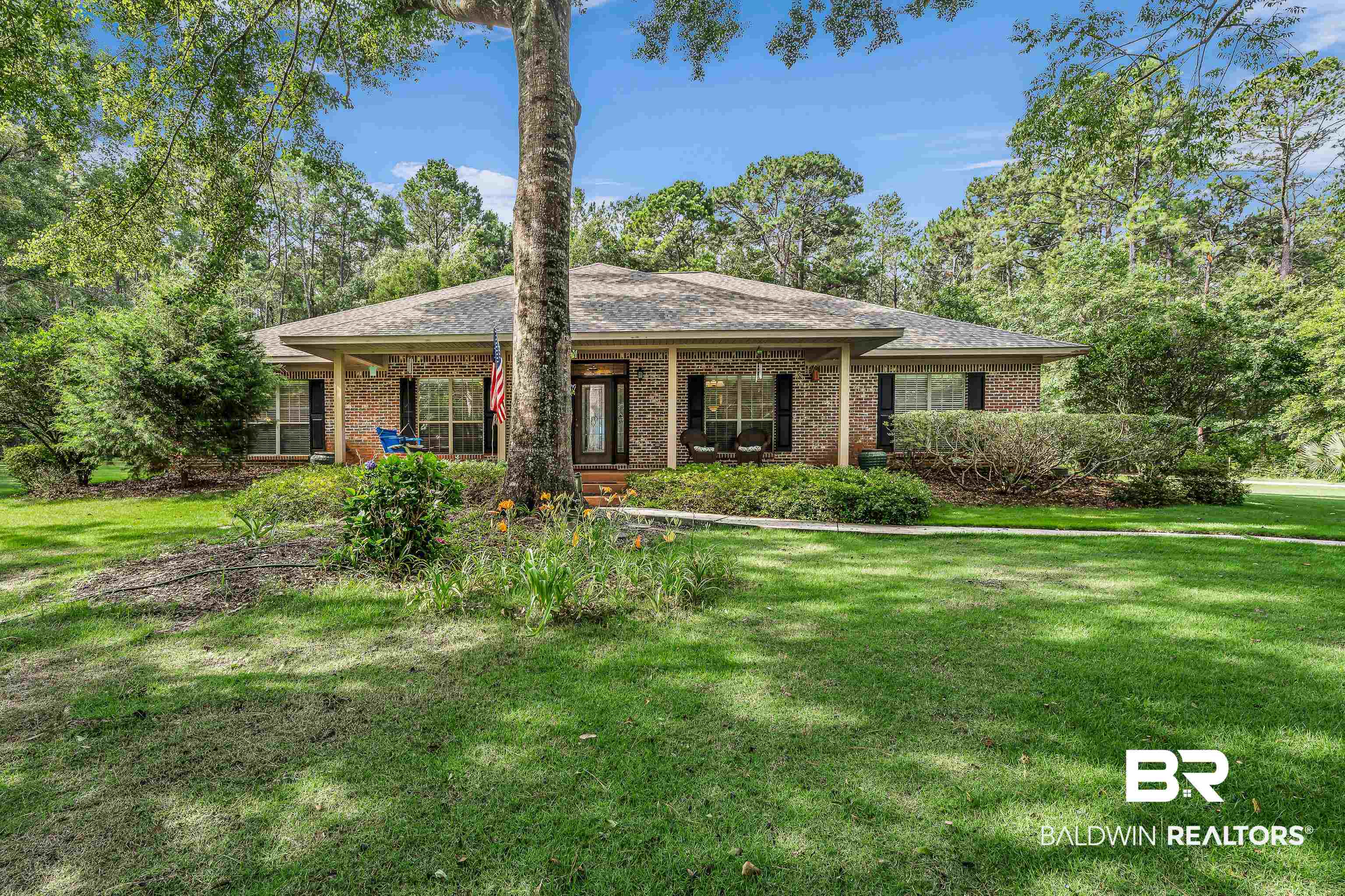 7014 Blakeley Road Daphne, AL 36527 - Photo 4 of 45 Brick exterior with a covered front porch and dark shutters