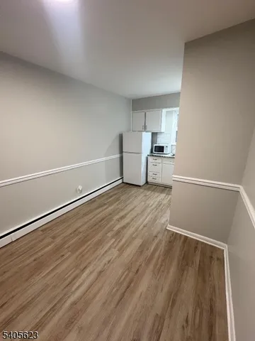 a view of a kitchen with wooden floor