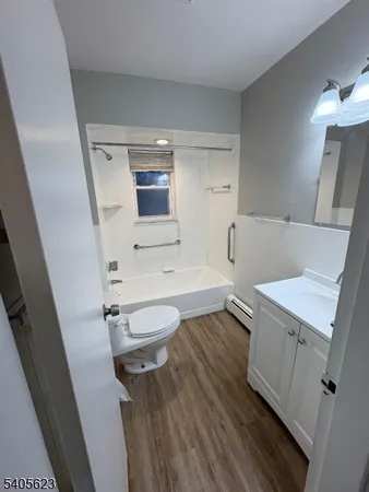 a bathroom with a sink a toilet and mirror