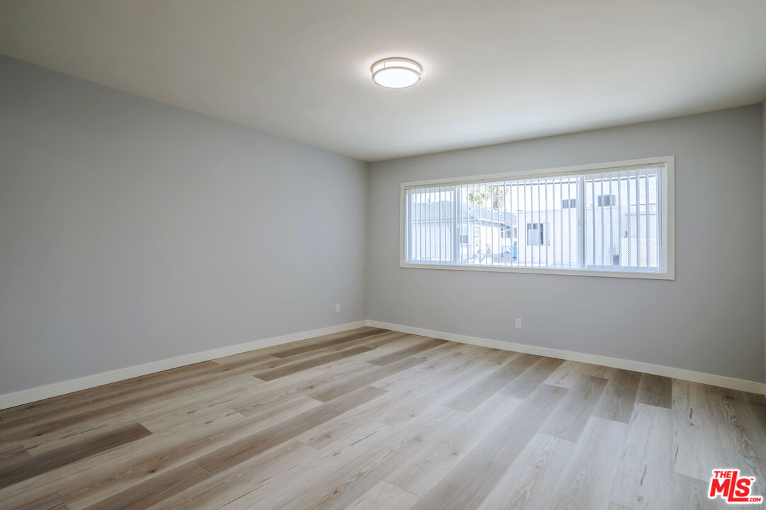 1116 San Rafael Avenue, Unit 6 Glendale, CA 91202 - Photo 12 of 23 a view of an empty room with wooden floor and a window