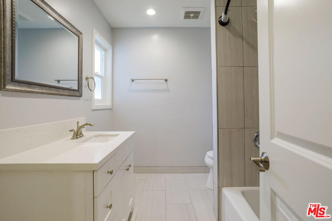 1116 San Rafael Avenue, Unit 6 Glendale, CA 91202 - Photo 21 of 23 a bathroom with a sink and a mirror
