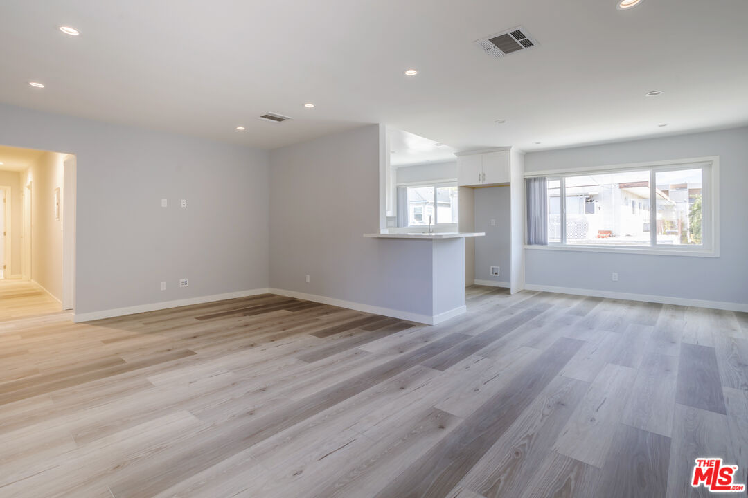 1116 San Rafael Avenue, Unit 6 Glendale, CA 91202 - Photo 4 of 23 an empty room with wooden floor and windows