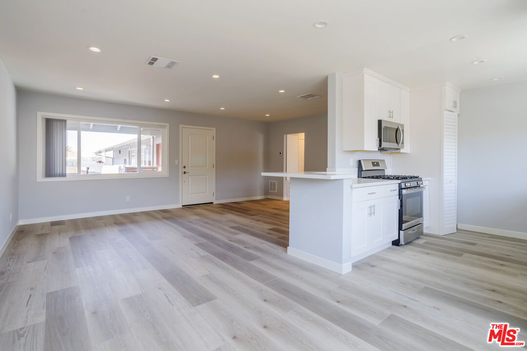 1116 San Rafael Avenue, Unit 6 Glendale, CA 91202 - Photo 5 of 23 a view of a kitchen with wooden floor and a sink