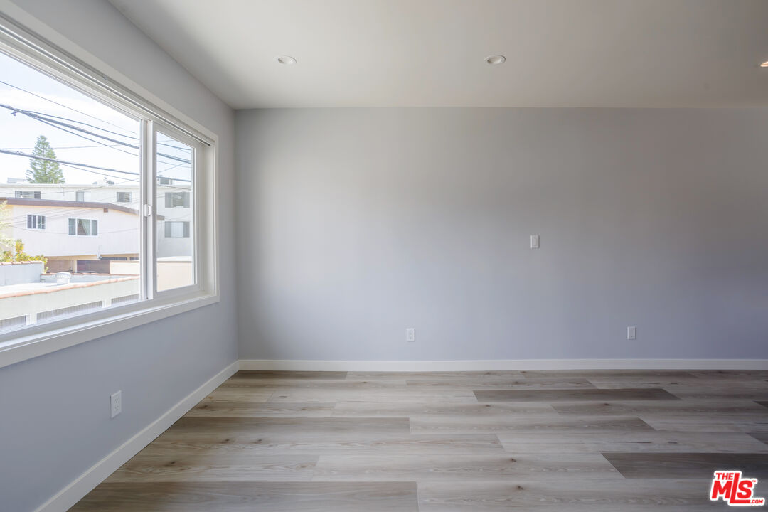 1116 San Rafael Avenue, Unit 6 Glendale, CA 91202 - Photo 10 of 23 a view of an empty room with wooden floor and a window