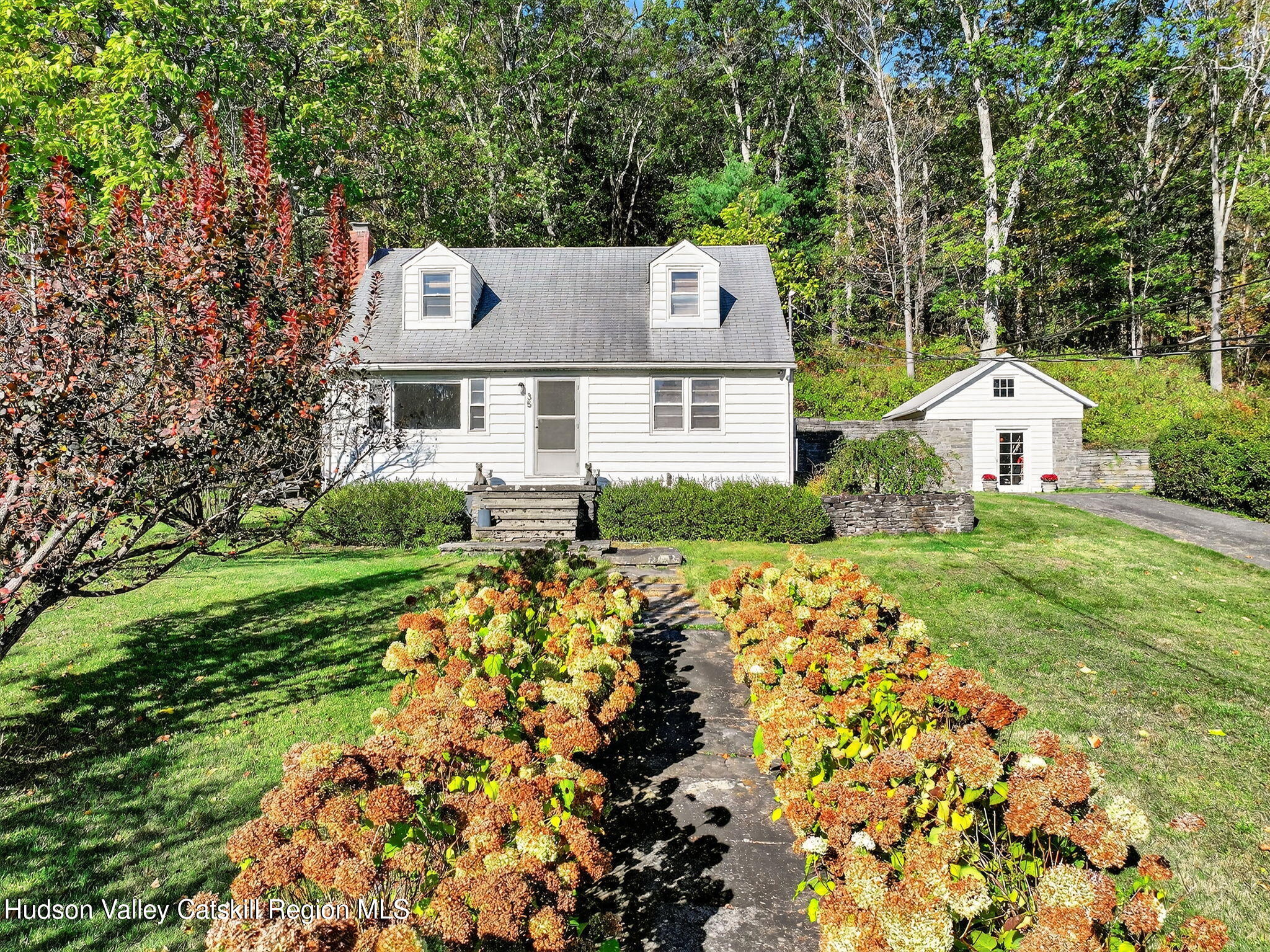 a front view of a house with garden
