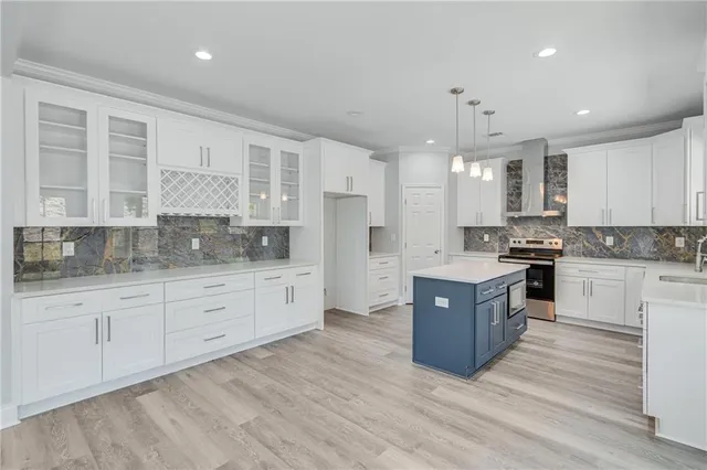 a kitchen with granite countertop cabinets a dining table and chairs