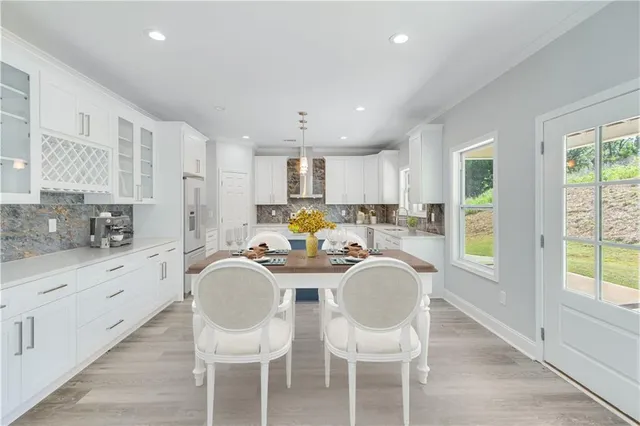 a living room with furniture a flat screen tv and a window