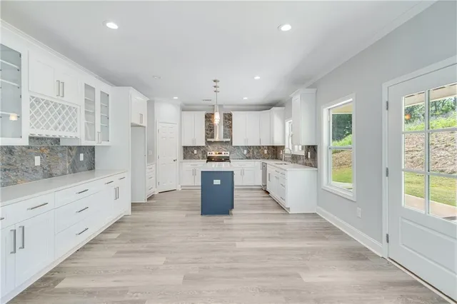 a living room with furniture and kitchen view