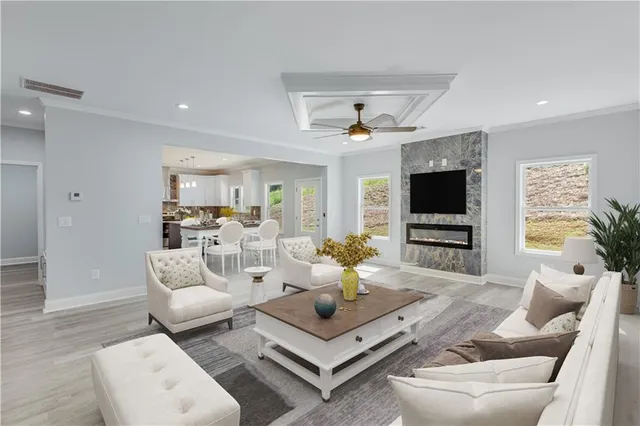 a view of empty room with wooden floor and ceiling fan