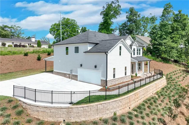 a white house that has tree in front of it