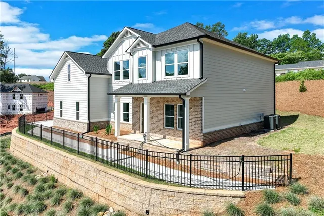 a front view of a house with glass windows and couches