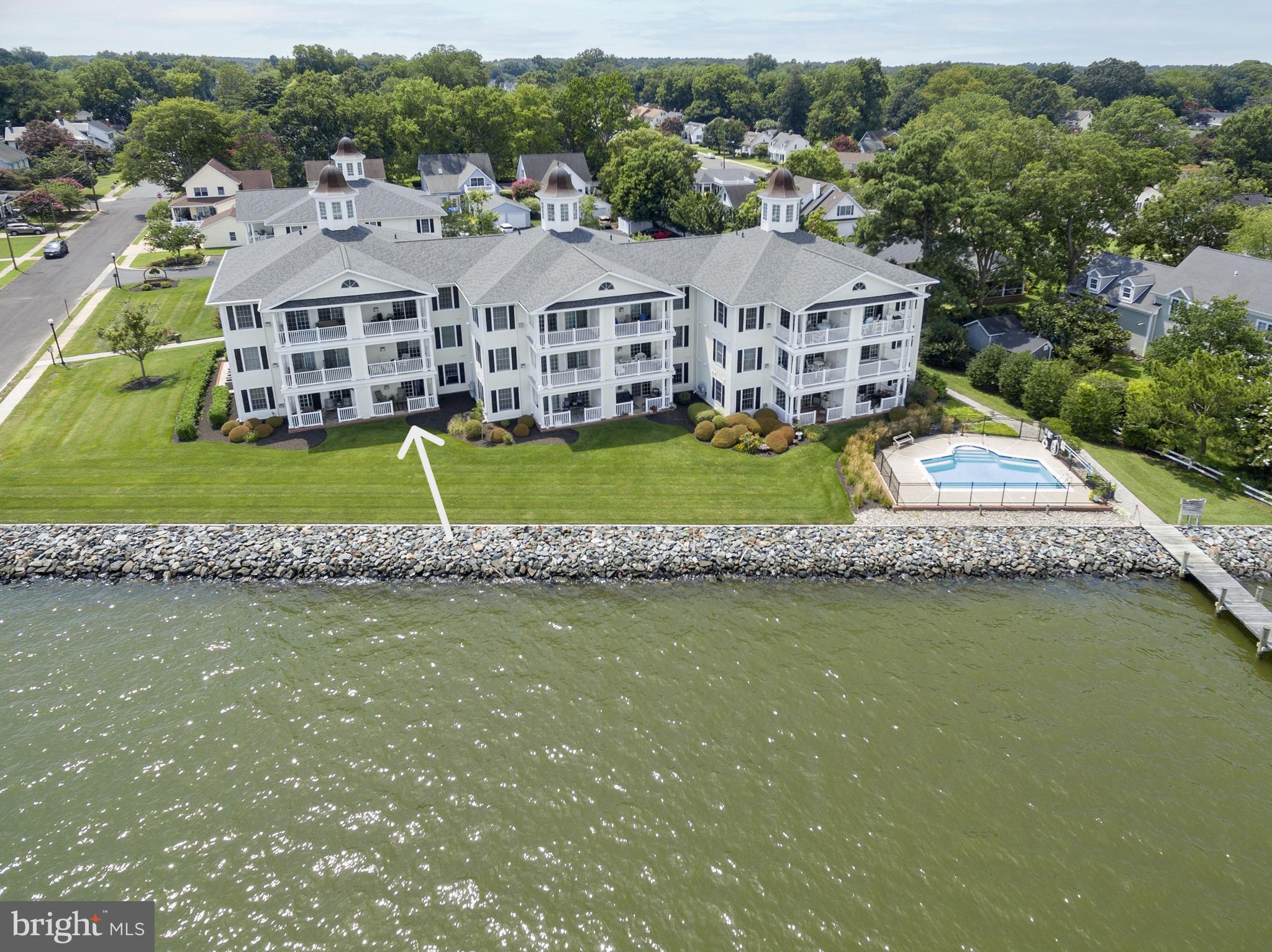 an aerial view of a house with a garden and lake view