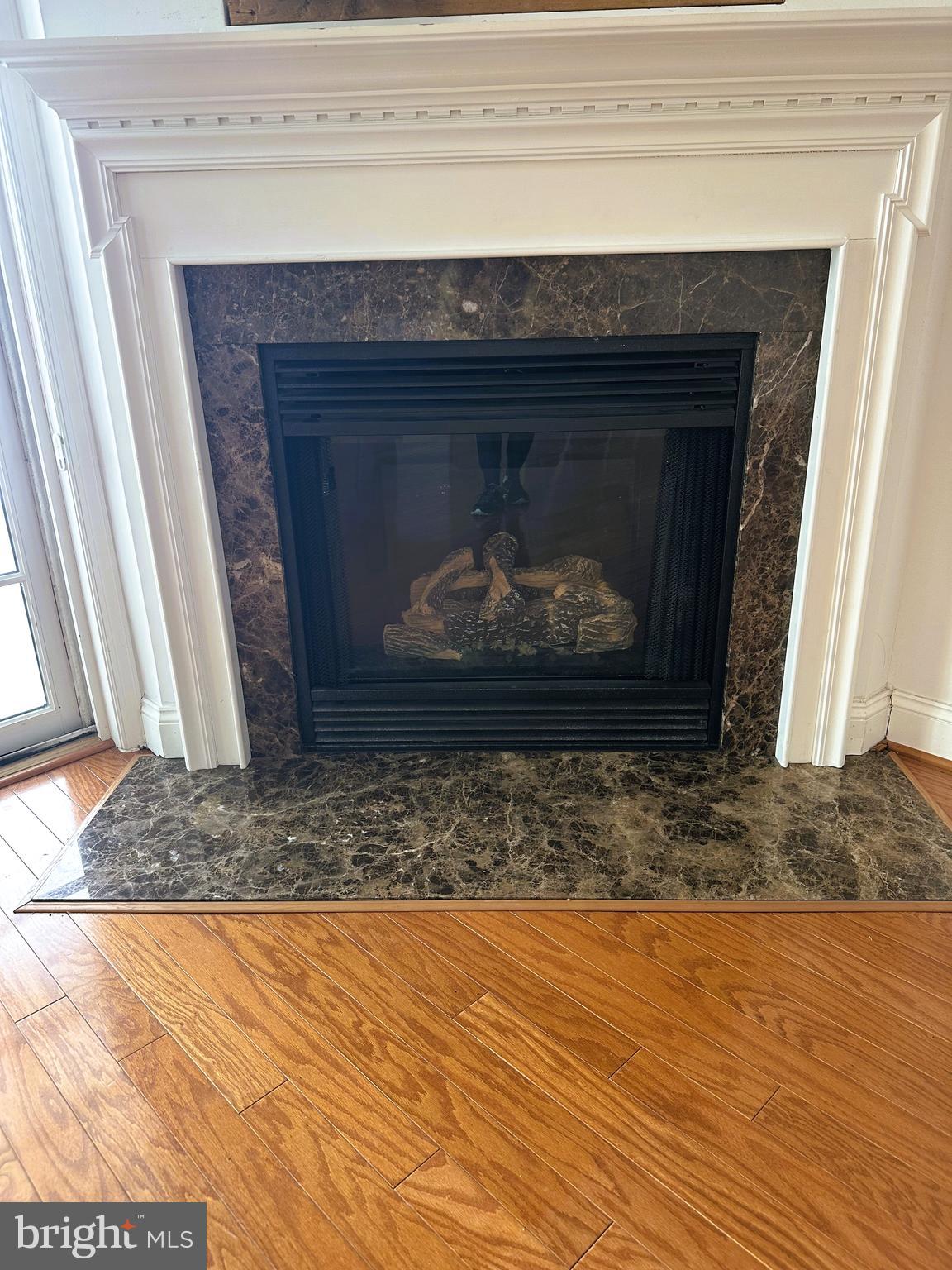 5 Oakley Street, Unit 102 Cambridge, MD 21613 - Photo 12 of 35 Gas fireplace with marble surround & mantle