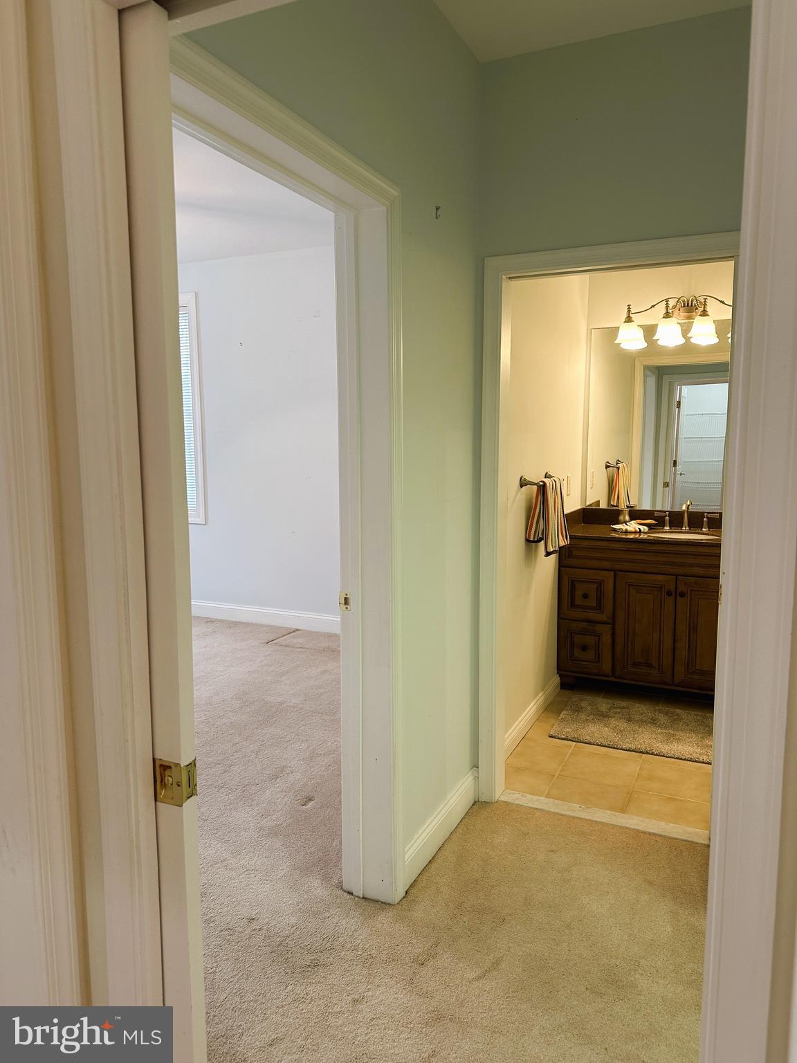 5 Oakley Street, Unit 102 Cambridge, MD 21613 - Photo 15 of 35 Primary bedroom and bathroom suite