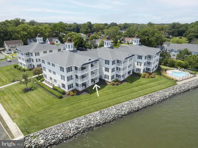 a view of a big building with a big yard and large trees