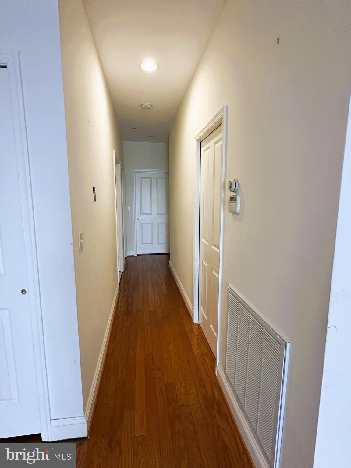 5 Oakley Street, Unit 102 Cambridge, MD 21613 - Photo 20 of 35 Hall with pocket doors to laundry and primary BR
