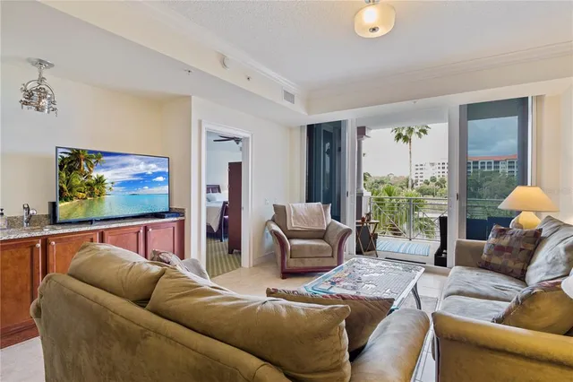a living room with furniture a lamp a rug and a large window