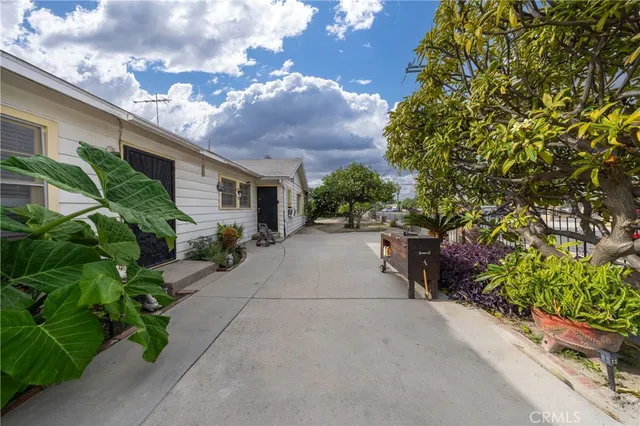 a pathway of a house with a yard