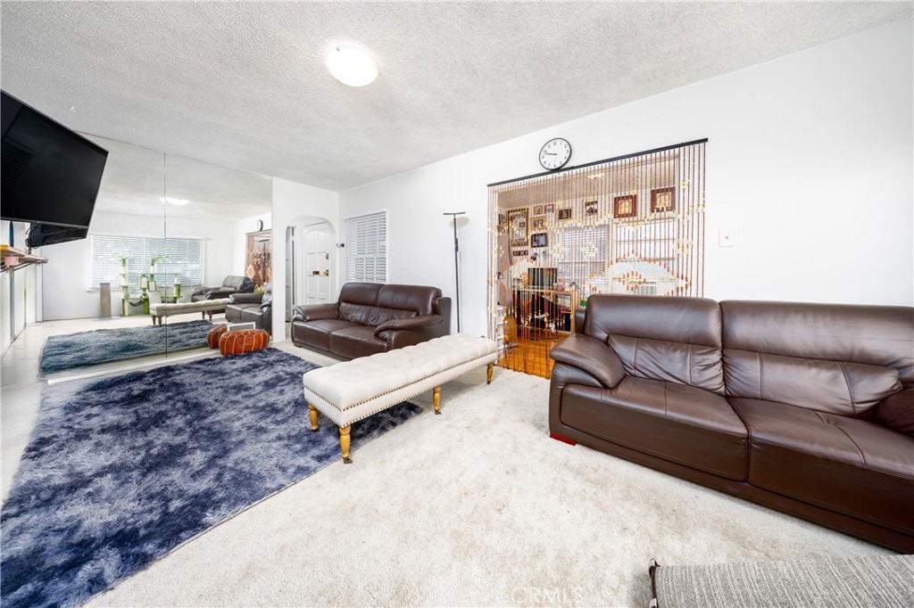 12203 Klingerman Street El Monte, CA 91732 - Photo 4 of 21 a living room with furniture and a flat screen tv