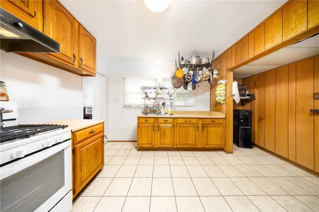 a kitchen with a stove a sink and a refrigerator
